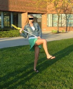 Playing lacrosse for the first time in a skirt...so she has an excuse to be girly!